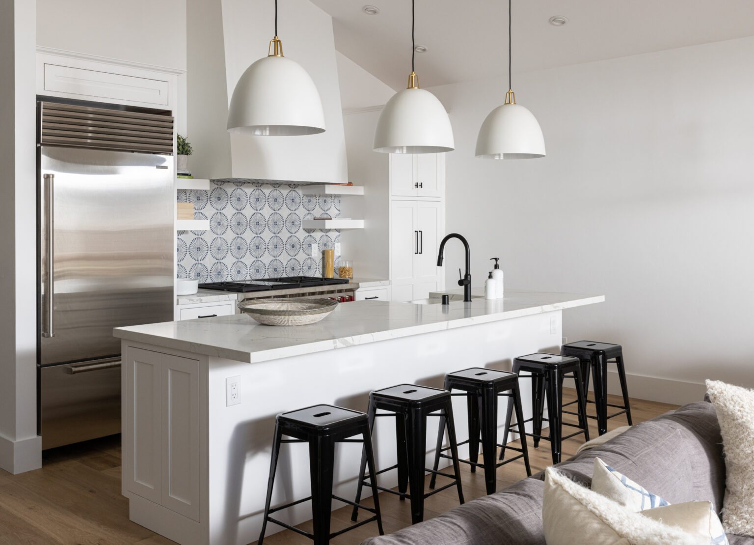 Bright kitchen with island and patterned backsplash