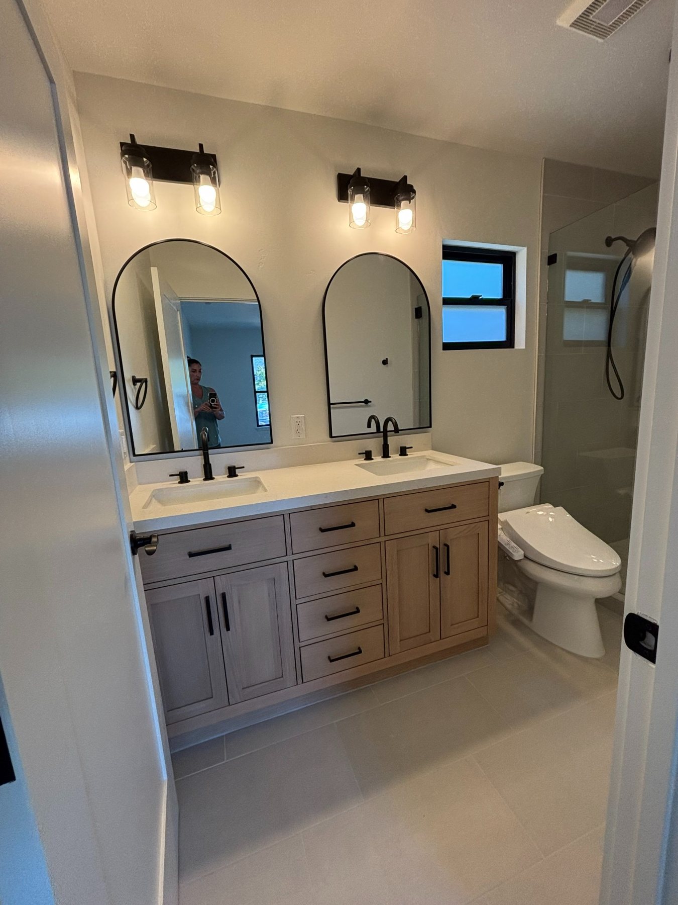Bathroom with double vanity and shower