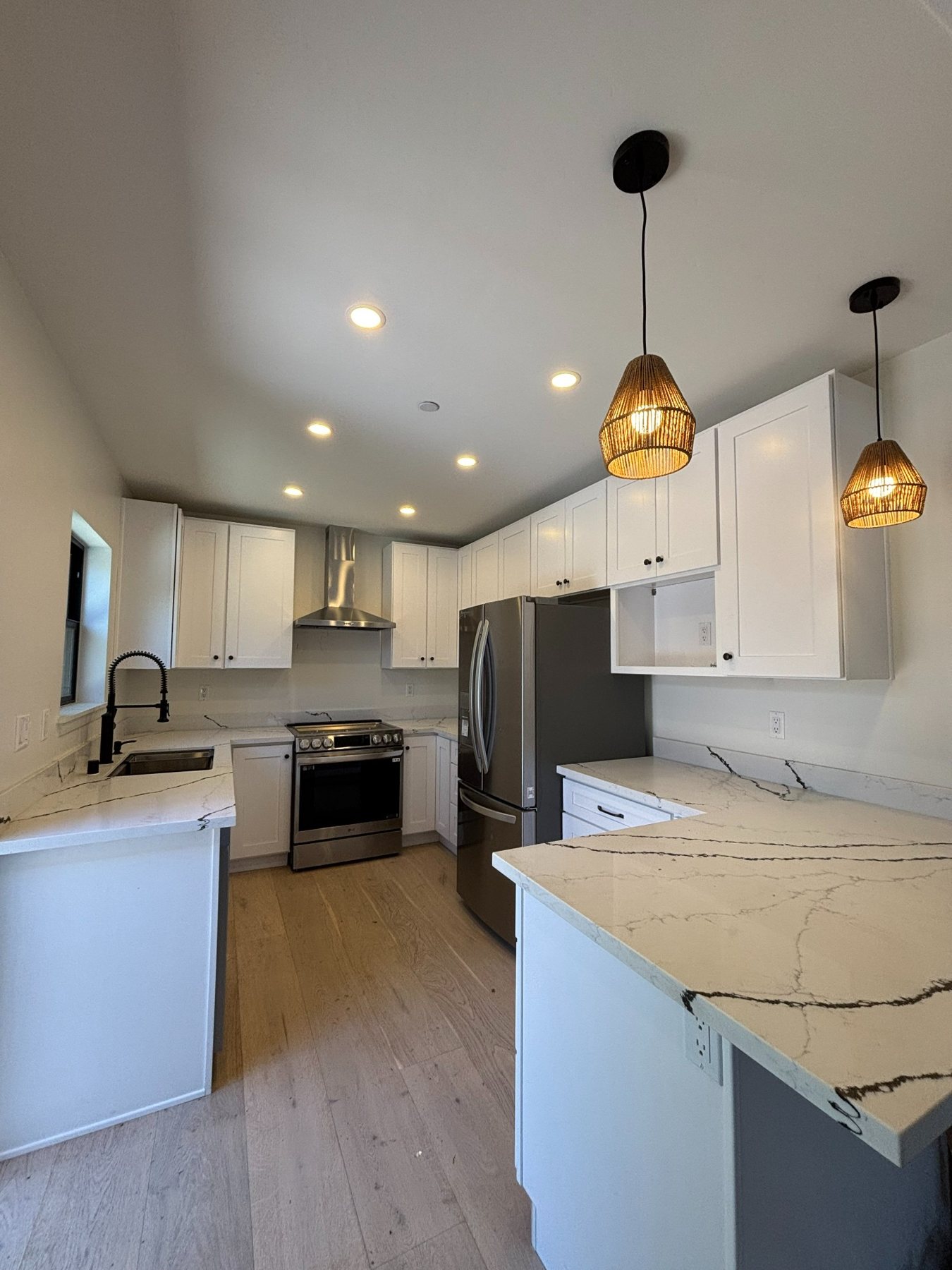 Kitchen with white cabinets and pendant lights